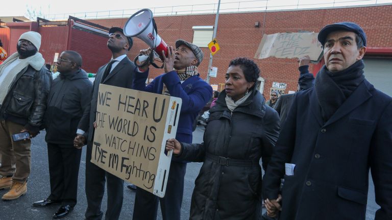 Brooklyn Borough President Eric Adams, center, joins demonstrators Sunday.
