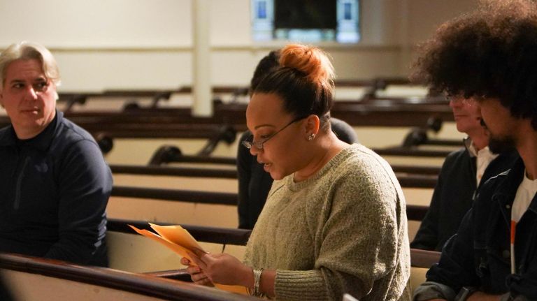 The six strangers read their histories, which intertwined, out loud inside the church.