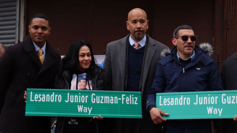 Lesandro&nbsp;"Junior" Guzman-Feliz's parents, Leandra Feliz and&nbsp;Elisandro Guzman, hold the street signs memorializing their&nbsp;son, with City Councilman Ritchie Torres, left, and Bronx&nbsp;Borough President Ruben Diaz Jr., center.
