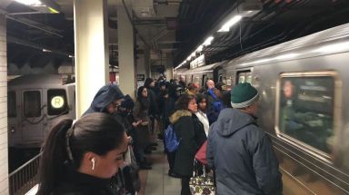 Subway riders wait for trains at the Dekalb Avenue station, where B and Q trains were temporarily rerouted due to fallen tree limbs on the tracks.    