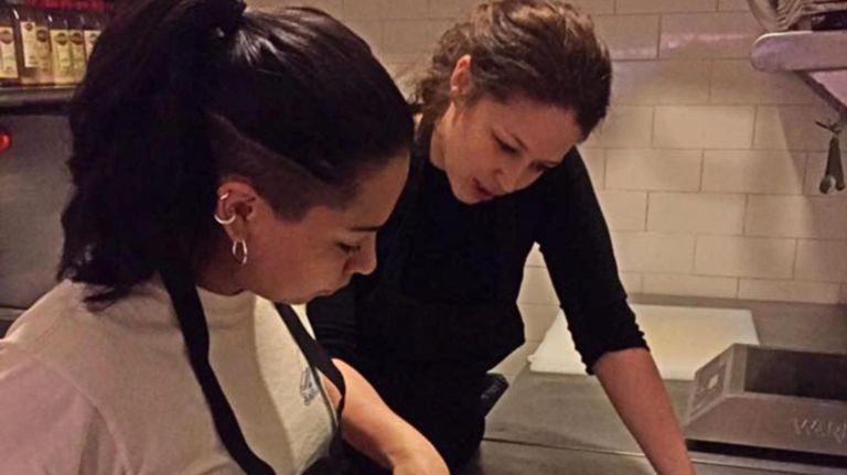 Sara Antes, right, goes over menu choices with fellow chef Priscilla Aguilar.