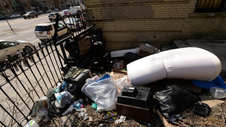 The garbage piles on the property are attracting rats, the tenants say.