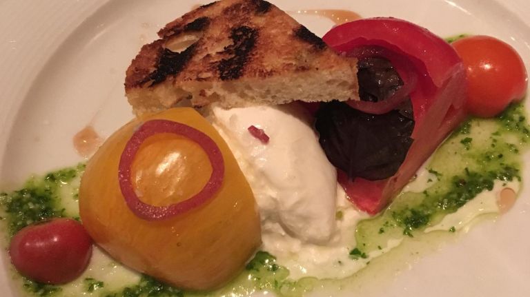 Dine on&nbsp;local heirloom tomatoes with burrata at Michael Mina's Bourbon Steak.