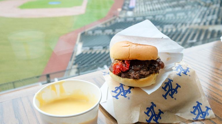 Citi Field ups its 2019 food game with dumplings and pizza cupcakes 5 Sliders and Sinkers' The Champ Slider, with house-spiced bacon, onion agrodolce and roasted tomatoes, served with a side of cheddar cheese sauce.