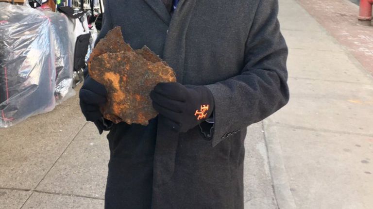 A piece of rusted debris fell from the 7 train subway tracks onto a moving vehicle in Queens, damaging the windshield, Councilman Jimmy Van Bramer said.