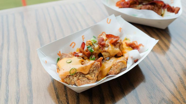 Citi Field ups its 2019 food game with dumplings and pizza cupcakes 7 Fuku's Loaded Bites and Fries, with a spicy cheese sauce and bacon.