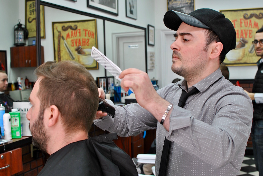 Chelsea Gardens owner, Rudy, trims a client’s hair