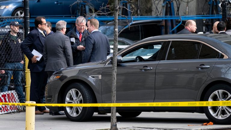 Police investigate a shooting that injured an officer and killed a suspect on Thursday in Washington Heights.