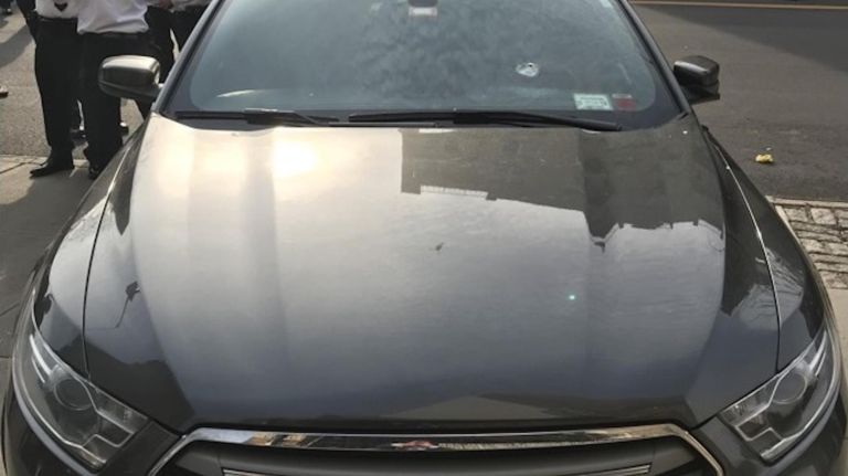 The NYPD released a photo of a bullet hole in the windshield of an unmarked police car following a fatal police-involved shooting in Washington Heights on Thursday.