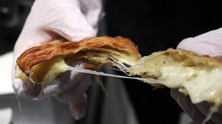 One of the many flavors of Godiva's croiffle is three cheese --&nbsp;a croissant filled with havarti, gouda and swiss cheeses and then pressed on a waffle iron.&nbsp;
