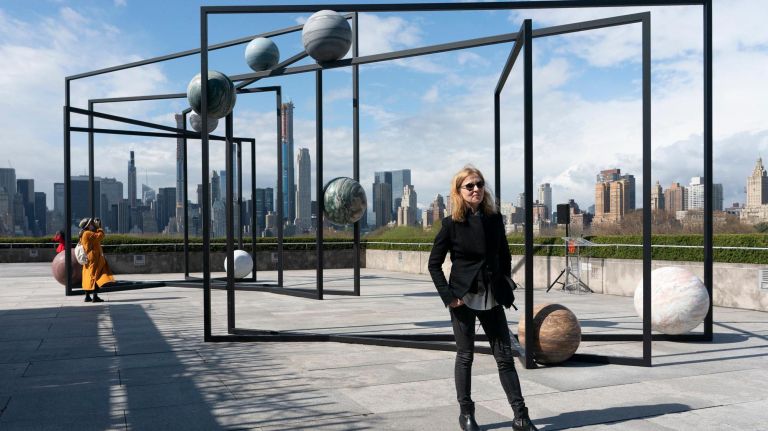 Berlin-based artist Alicja Kwade, right, poses for a photograph in front of her "ParaPivot."