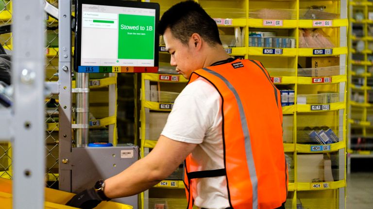 Jing Zhang works as a stower at the Amazon Fulfillment Center on Staten Island on&nbsp;Tuesday.