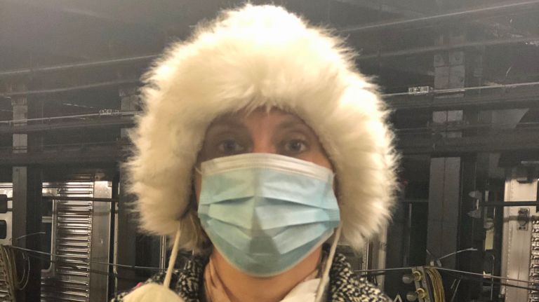 Freelance writer Ann Votaw wears her surgical mask while waiting for her subway train on April 9, 2019.
