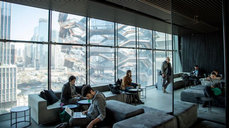 A lounge at the Tisch Skylights, a rehearsal space and creative lab for local artists in Bloomberg building of the Shed, features a view of the Vessel.
