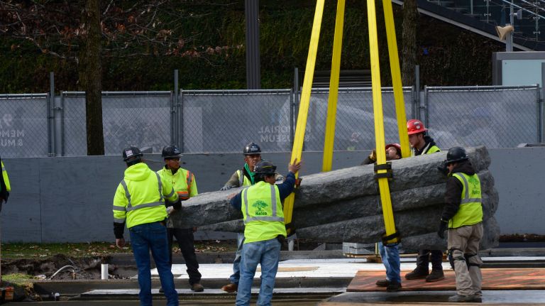 A new memorial is installed at National September 11 Memorial & Museum plaza 2 A crew of construction workers helps guide six multiton stones as they are lifted by crane at the National September 11 Memorial & Museum plaza on Saturday as part of the memorial in honor of those sick and dying from World Trade Center dust.