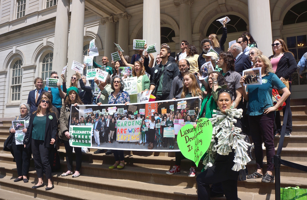 Supporters of the Elizabeth St. Garden rallied on the City Hall steps before a City Council hearing on an affordable housing project slated for the site. (Photo by Sarah Ferguson)