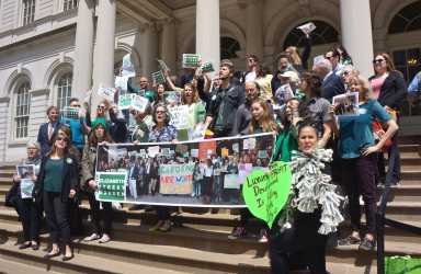 Supporters of the Elizabeth St. Garden rallied on the City Hall steps before a City Council hearing on an affordable housing project slated for the site. (Photo by Sarah Ferguson)