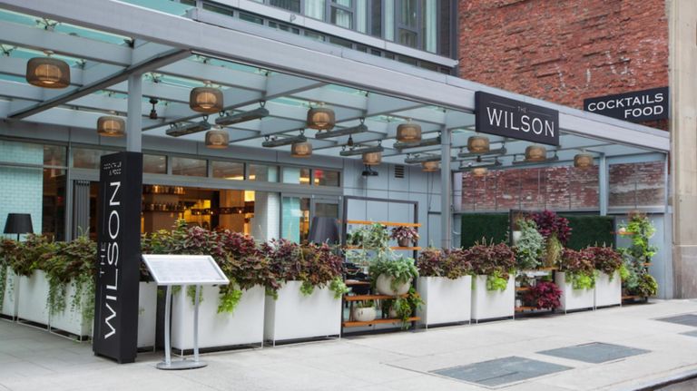 The Wilson's front patio features cornhole, ping-pong, giant Jenga, and much more to enjoy while guests drink rosé or beer.