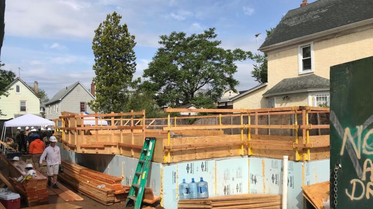 The framework of a new affordable home in South Richmond Hill, Queens, begins to take shape on Thursday.