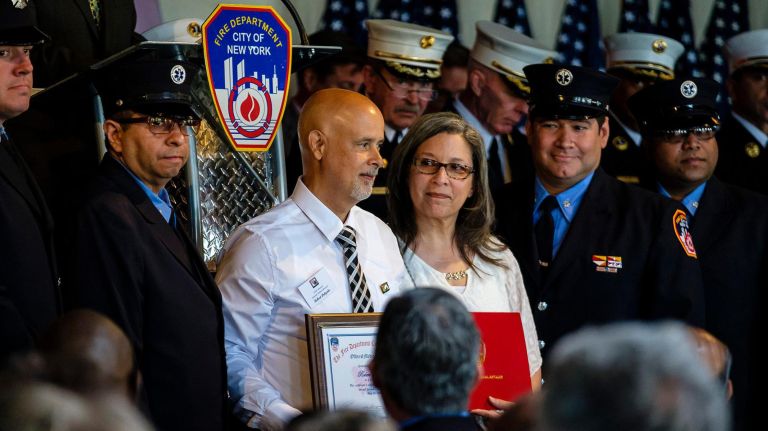 Survivor Robert Delgado receives a plaque at the 25th annual FDNY Second Chance Ceremony at Liberty Warehouse in Red Hook, Tuesday, May 21.