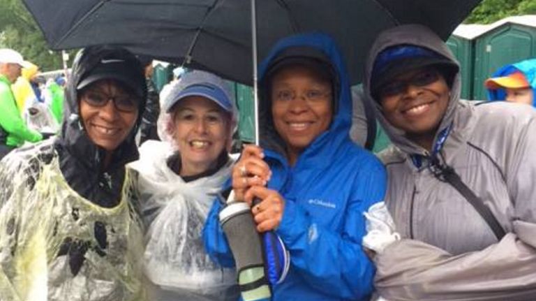Rochelle Ann Rosa, second from left, and Elena McCalla, third from left, show their plastic bag "fashion style" after the Brooklyn Half Marathon on May 19, 2018.