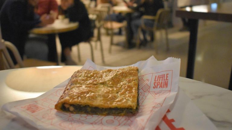 NYC markets update the classic food court with international flavors 11 An empanada at Mercado Little Spain at Hudson Yards.