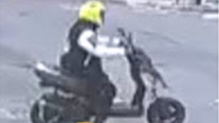 A man on a scooter stole a woman's purse and dragged her down the sidewalk in Lenox Hill, surveillance video shows.