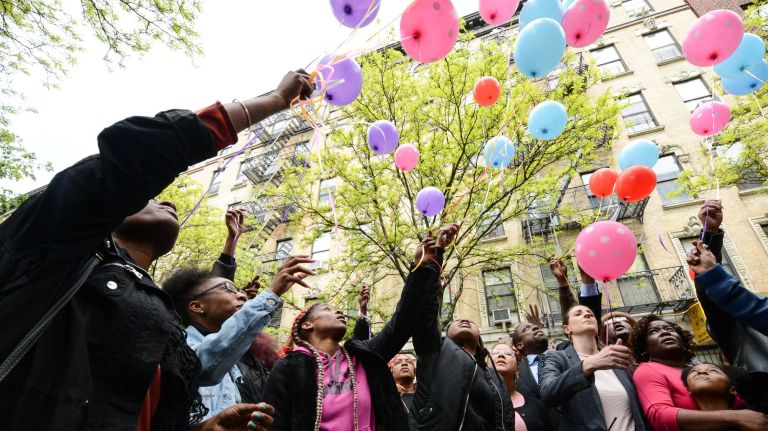 Mourners release balloons during a memorial outside of PS 194 on Thursday for the six victims of Wednesday's&nbsp;fire in Harlem.&nbsp;