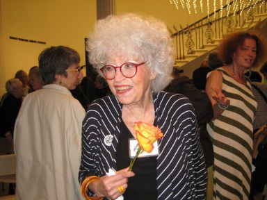Gloria Sukenick, after a 2015 ceremony, with the flower that accompanied her Clara Lemlich Award. (Villager photo by Dusica Sue Malesevic)