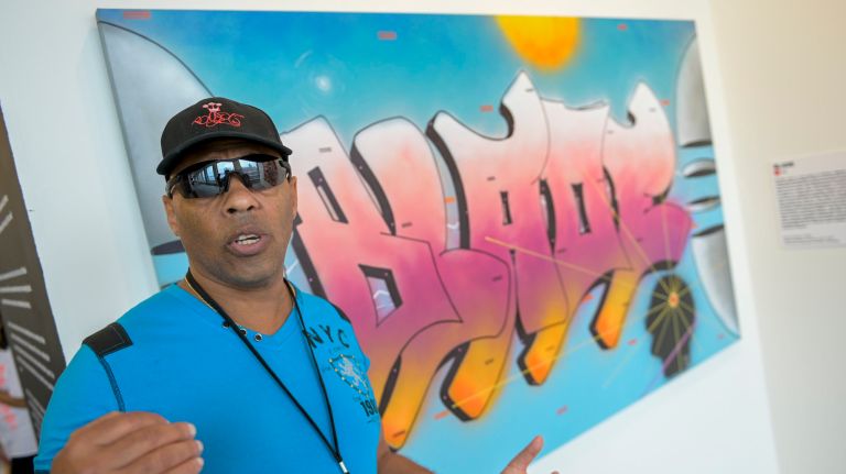 'Beyond the Streets' exhibit displays sweeping overview of street artists 5 The artist BLADE stands in front of his work.