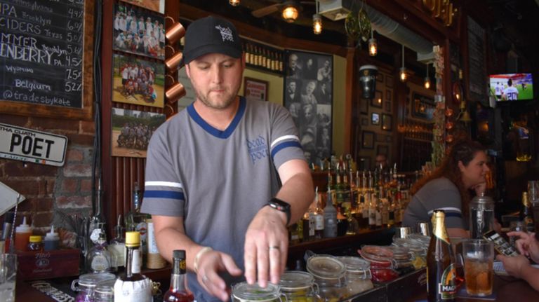 Kevin Cole mixes a drink at The Dead Poet, a bar he owns on the Upper West Side. A former English teacher, Cole dubs his seasonal menus "Reading Lists."