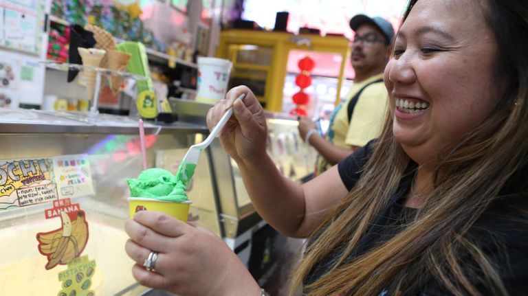 Jun Segismundo, from Piscataway, NJ,, digs into a cup of pandan ice cream, which is based on a tropical leaf.