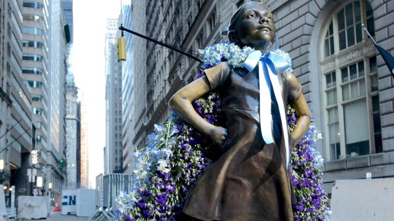 Fearless Girl wore a cape of flowers by Lewis Miller Design for International Women's Day in March 2018.