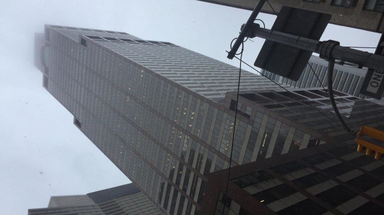 The rain and fog nearly obscure the roof of 787 Seventh Ave., where a helicopter crash-landed on the roof Monday afternoon, according to officials.