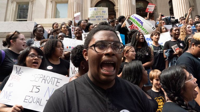 School segregation, for Teens Take Charge, is black and white 3 Students protest how segregated city high schools are on the steps of Tweed Courthouse.