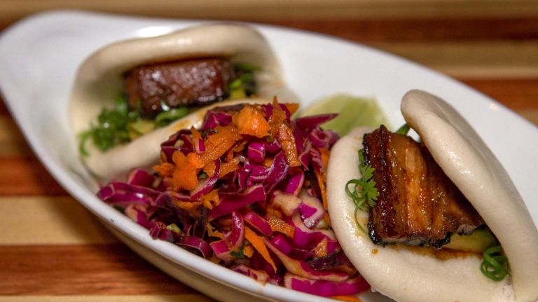 Foodie's tips on where to eat in the Hamptons this summer 3 Steamed pork buns with red cabbage and carrot slaw are a savory appetizer at Highway Restaurant & Bar.