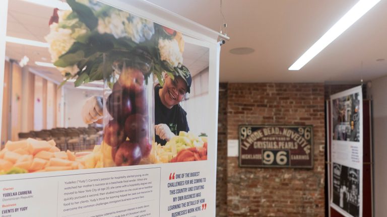 The exhibit's banners feature modern-day business owners at the top, and photographs of historic immigrant entrepreneurs on the bottom.