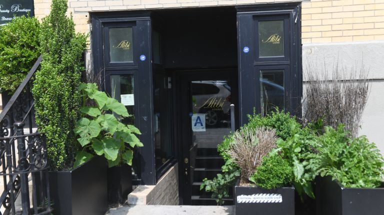 Two rainbow flags were burned outside the Alibi Lounge in Harlem on Friday, police said.