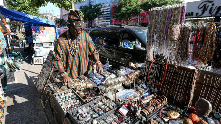 A Harlem tour, complete with restaurant, bar and museum picks 6 Nana Yaw sells items from Ghana along 125th Street on June 26, 2019.
