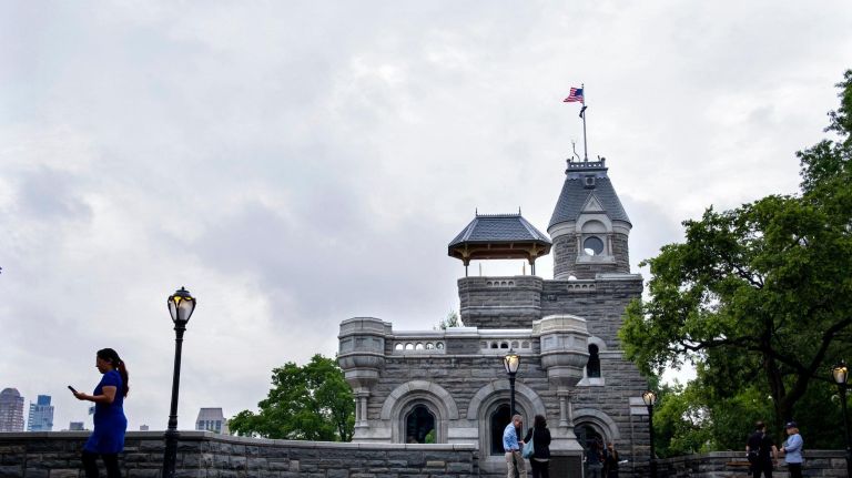 People attending a preview of Central Park's Belvedere Castle stand and walk along newly installed bluestone pavers on&nbsp;June 18.
