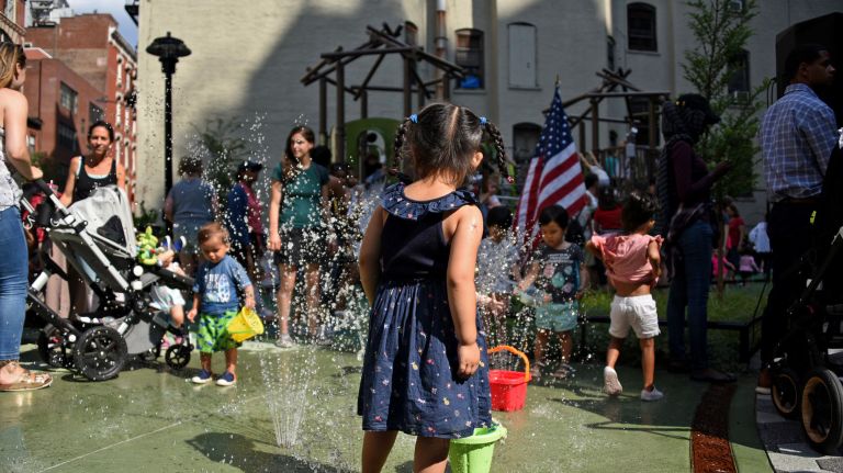 Children play in spray fountains at the newly constructed Chelsea Green park on West 20th Street.&nbsp;The quarter-acre lot, located between Sixth and Seventh avenues, is on the site of a former Department of Sanitation facility in a neighborhood that has not seen a new park in more than 40 years.