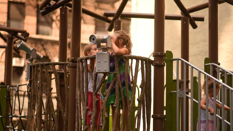 Kids look through viewfinders at the ribbon-cutting ceremony for the Chelsea Green on Thursday.