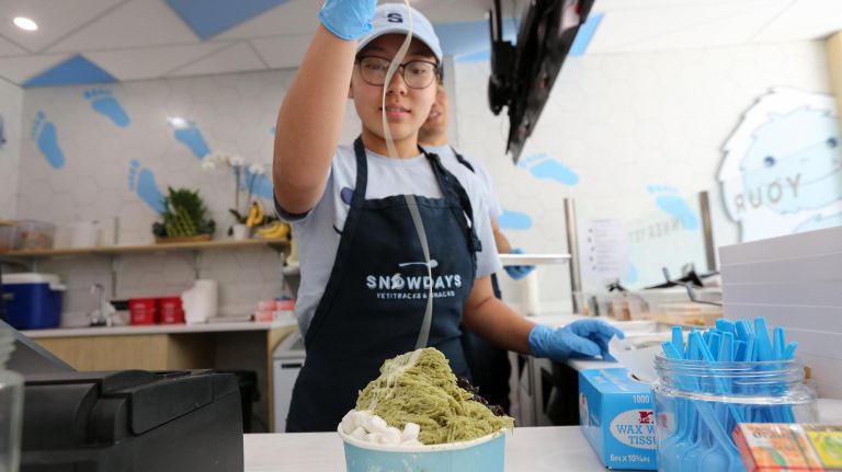 At Snowdays, shaved cream comes with a taste of nostalgia 3 Yujin Ko adds condensed milk to a cup of " Made in Taiwan" at Snowdays.