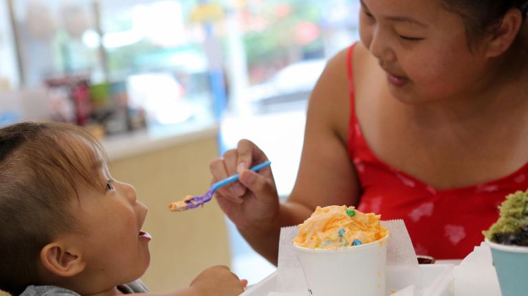 At Snowdays, shaved cream comes with a taste of nostalgia 4 Winnie Wong feeds her son Caleb, 3, a taste of orange creamsicle at Snowdays in Bay Ridge on Tuesday.