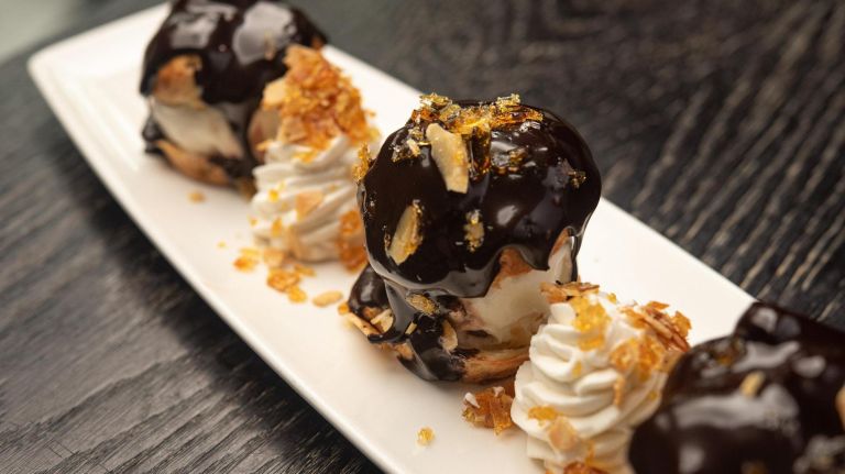 Brooklyn Museum's restaurant pays homage to world-famous Maxim's de Paris 4 Profiteroles au Chocolat with vanilla ice cream, praline and warm chocolate sauce.