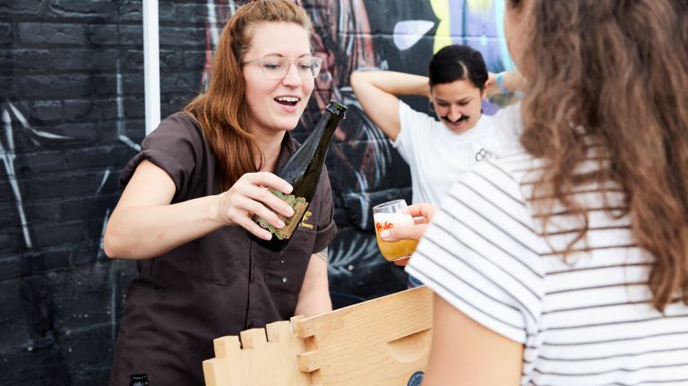Beer With(out) Beards includes a tasting festival with 24 woman-friendly brewers represented. Pictured, Plan Bee Farm Brewery co-owner Emily Watson serves a brew at the inaugural fest last year.