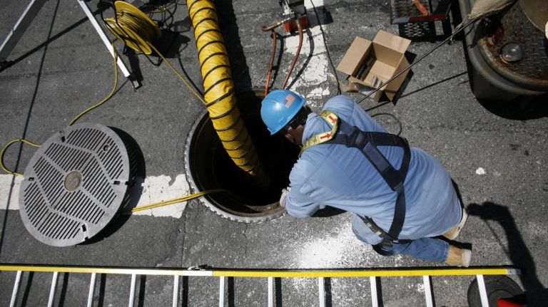 A Con Edison employee works on Ditmars Boulevard during the Queens blackout on July 24, 2006.