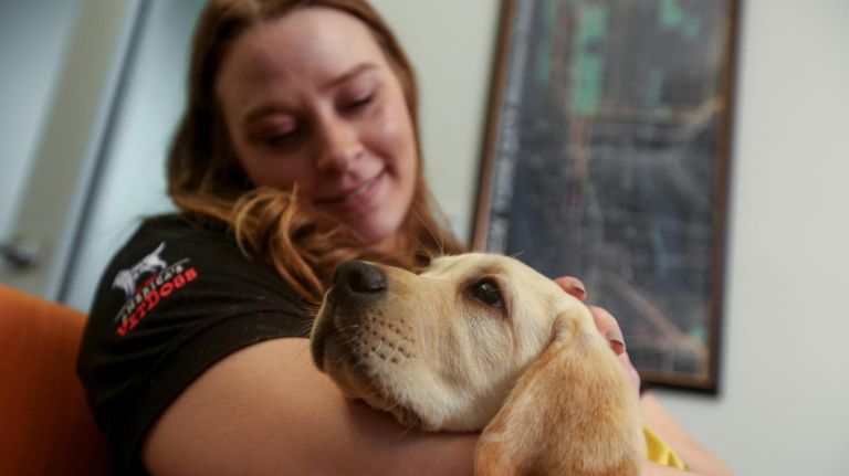 Meet Guide Dog Gil, a little pup on a big journey 3 Lorin Bruzzese, the puppy program manager at the Guide Dog Foundation, cuddles with Gil at the amNewYork office on June 6.