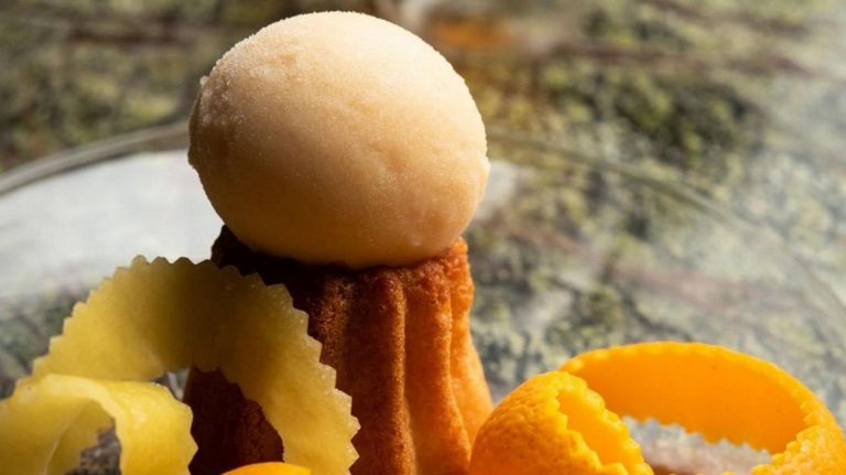 The Chanson Dessert Bar's Passionfruit Rum Baba involves a rum punch-soaked cake and a scoop of banana-passionfruit sorbet, with a sidecar.