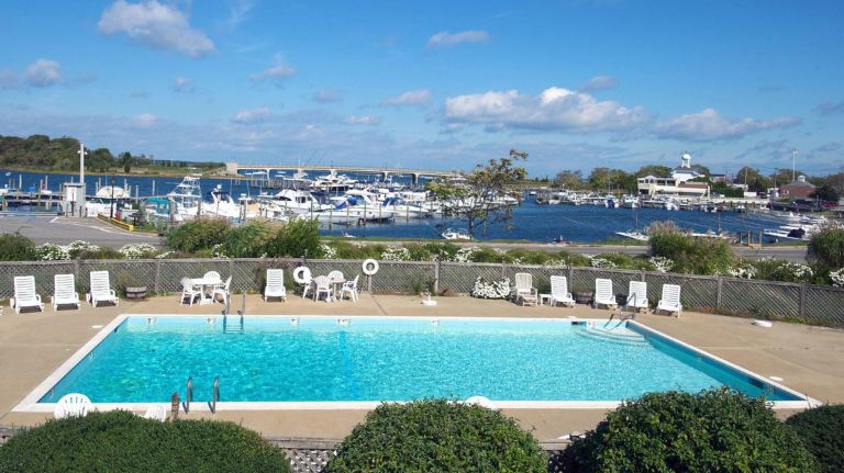 View of the pool and the marina from a second-floor terrace at Baron's Cove Inn in Sag Harbor.